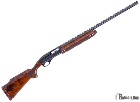 Picture of Used Remington Model 1100 Classic Trap Semi-Auto Shotgun - 12Ga, 2-3/4", 28", Vented Rib, High Polish Blued, Engraved Receiver w/ Gold Inlay, Hi-Gloss American Walnut Stock, 4rds, Twin Bead Sights, 5 Chokes, Very Good Condition