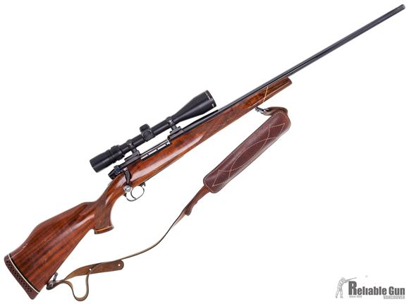 Picture of Used Weatherby Mark V Deluxe Bolt-Action 300 Wby Mag, 26" Barrel, With Bushnell Elite 4200 2.5-10x40mm Scope, Walnut Stock W/Crack By the Bolt Handle, Leather Sling, Fair Condition