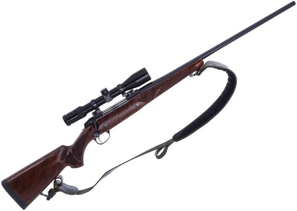 Picture of Used Sako 85 Hunter Bolt Action Rifle, 338 Win Mag, 24" Blued Barrel, Walnut Stock, Zeiss 2.5-10x42mm Diavari Scope, Some Solvent Marks On Comb, Otherwise Good Condition, Comes with Brass, Bullets & Assorted Reloading Equipment